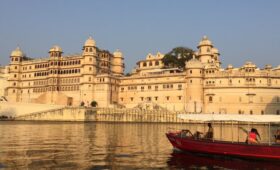 a boat in front of a building | Most Famous Lakes in Udaipur City of Lakes