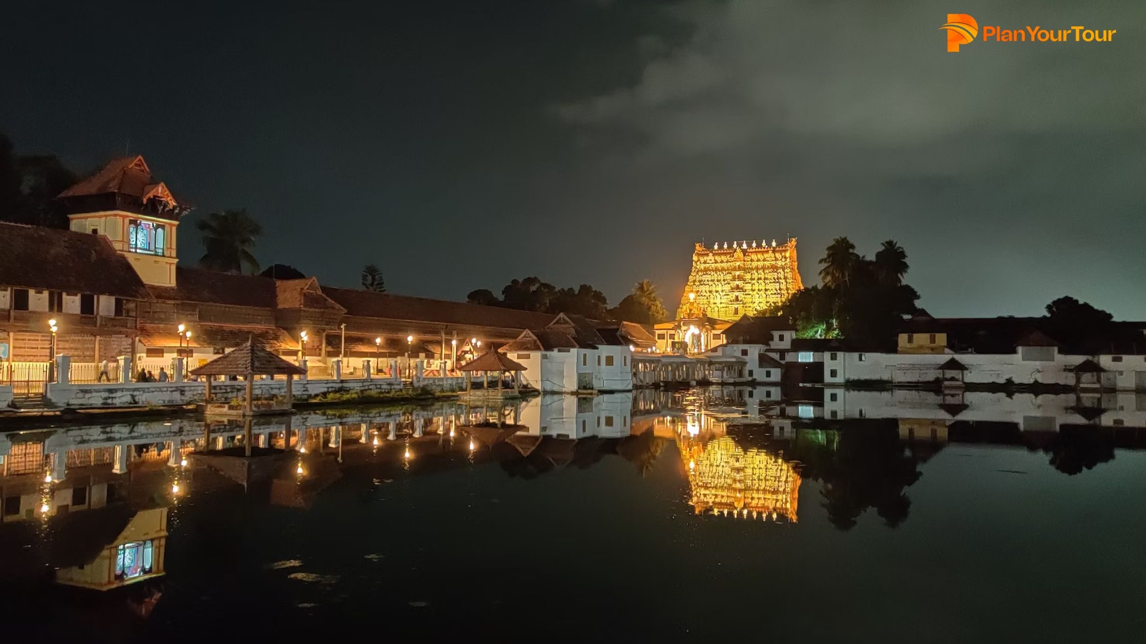 a building with lights on the water in Kerala : Temples in Kerala Religious Sites in Kerala